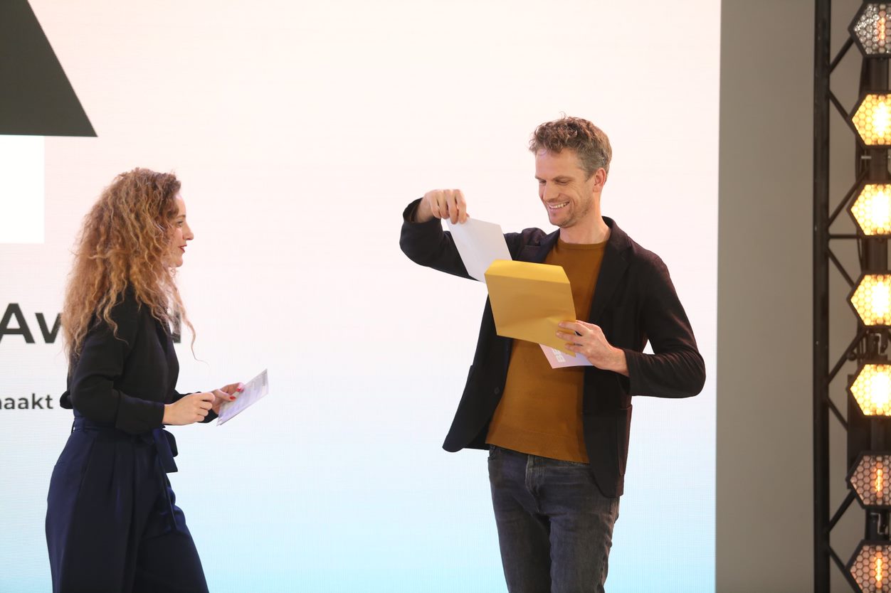 Sophie Stravens en Reinder Bakker met het onthullen van de winnaar van de ARC21 Innovatie Award. Beeld Cynthia van Dijke