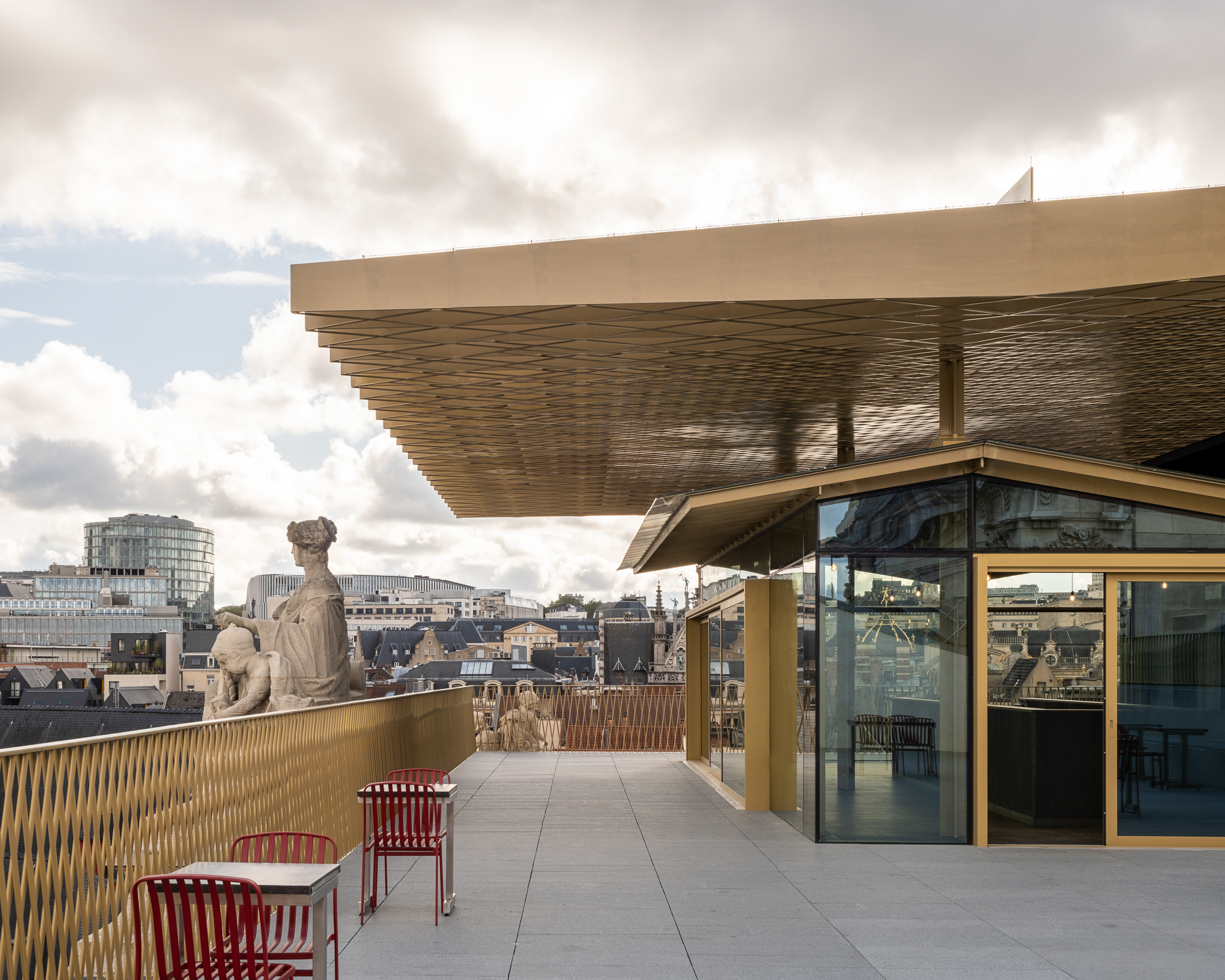 Boven op het dak van het beursgebouw kun je tussen de statige beelden al dan niet een van de honderden bieren nuttigen die het biermuseum presenteert. Beeld Sébastien Bez