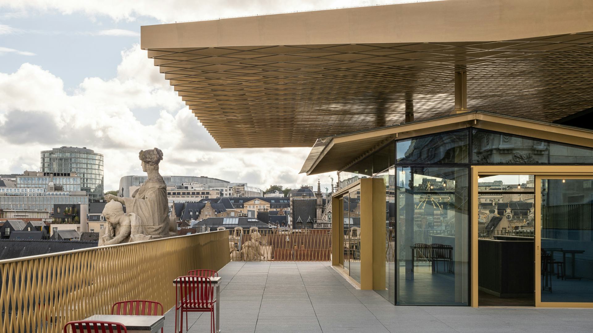 Boven op het dak van het beursgebouw kun je tussen de statige beelden al dan niet een van de honderden bieren nuttigen die het biermuseum presenteert. Beeld Sébastien Bez